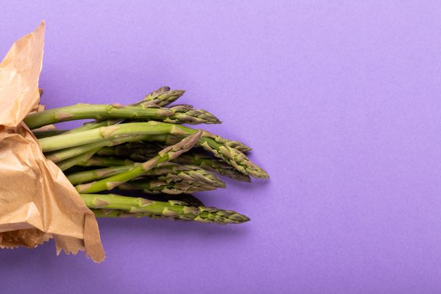 Overhead view of asparagus on purple background, copy space. unaltered, food, healthy eating, studio shot and organic.
