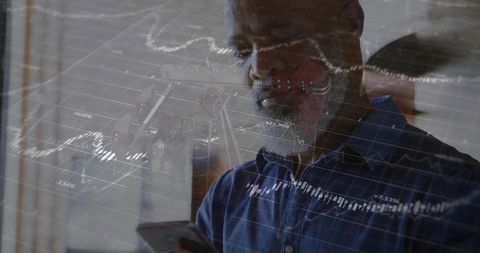 Professional Analyst Studying Financial Data with Chart Overlay