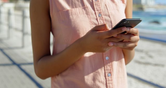 Woman Texting on Smartphone Outdoors by the Beach - Download Free Stock Images Pikwizard.com