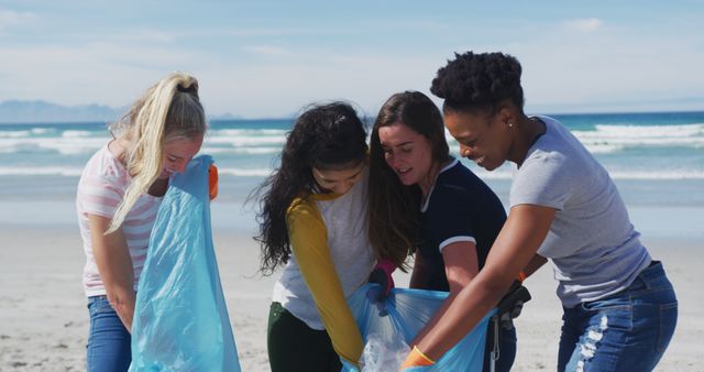 Diverse group of young women volunteering and cleaning up a beach on a sunny day. Perfect for promoting environmental conservation, community service, and teamwork campaigns. Useful for illustrating beach cleanup events, plastic waste reduction initiatives, and promoting environmental stewardship.