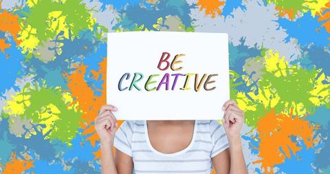 Person Holding 'Be Creative' Sign Against Colorful Abstract Background - Download Free Stock Images Pikwizard.com