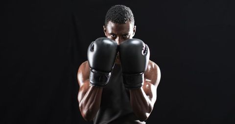 Focused Boxer in Gloves Ready for Intense Training Session