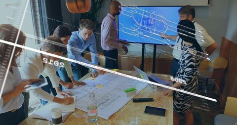 Diverse Team Collaborating on Blueprint and Presentation