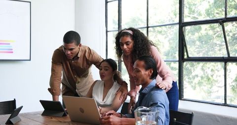 Diverse Team Collaborating During Enthusiastic Office Meeting
