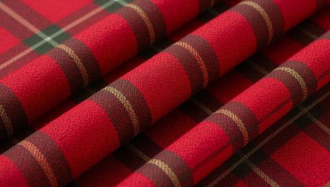 Showing Red Tartan Fabric Folding Into Ridged Plaid With Green-Gold Accent Stripes
