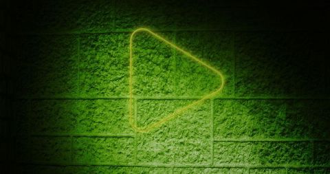Neon Green Play Button on Textured Brick Wall Background