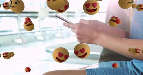 Woman browsing phone with heart-eyes emojis in modern space