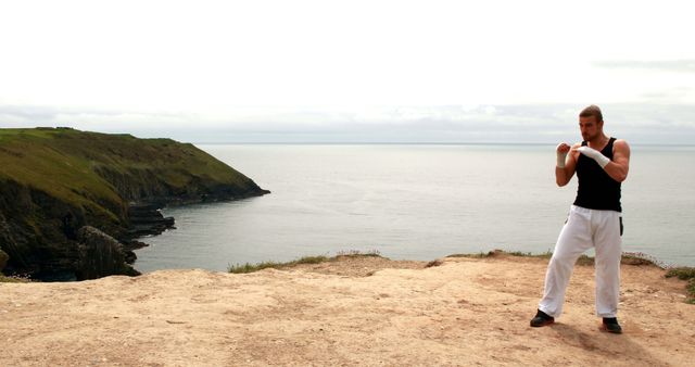 Fit Man Practicing Boxing on Cliffside by Ocean - Download Free Stock Images Pikwizard.com