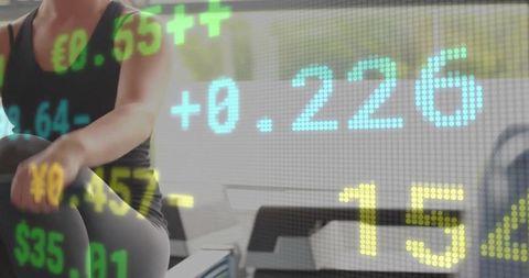 Woman Exercising Row Machine with Financial Data Overlay