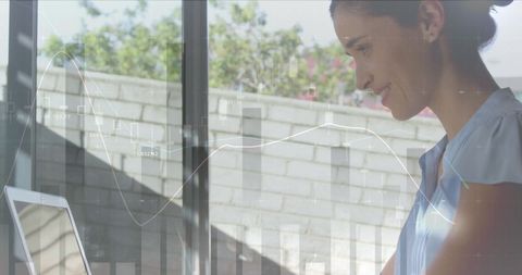 Businesswoman Analyzing Data on Laptop at Modern Office