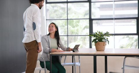 Friendly Business Discussion in Modern Office