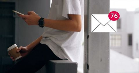 Young adult viewing high email notifications on smartphone