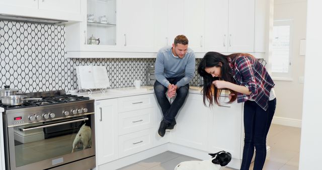 Young Couple Spending Time in Modern Kitchen with Pet Dog - Download Free Stock Images Pikwizard.com