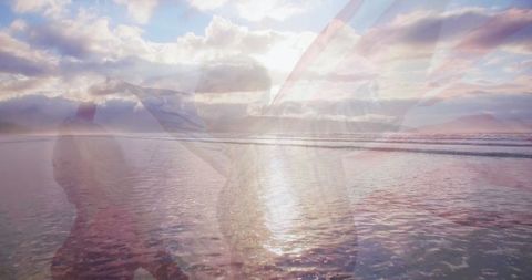 Couple with American Flag at Ocean Beach During Sunset