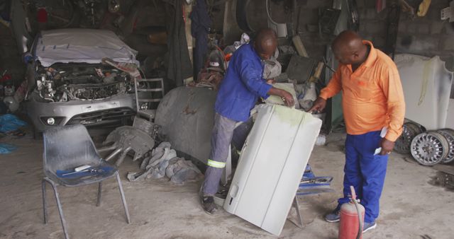 Two Mechanics Repairing Car Door in Workshop - Download Free Stock Images Pikwizard.com