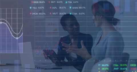 Businesswomen analyzing financial graphs and market data