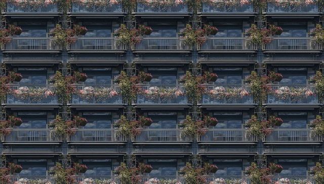 Repeating balcony modules on urban facade featuring flowering planters and glass railings