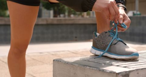 Woman Preparing for Jog by Tying Sporty Sneaker Laces - Download Free Stock Images Pikwizard.com