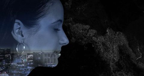 Double Exposure Profile of Woman with Urban Night Skyline