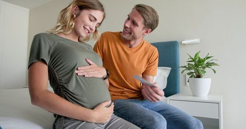 Expecting Couple Engaging in Joyful Moment at Home