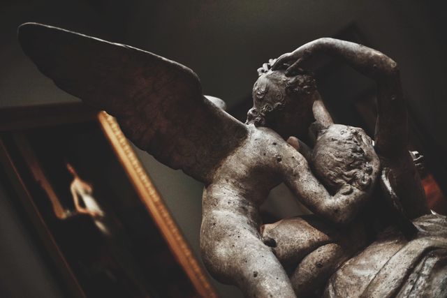Vintage Sculpture of Winged Figures in a Tender Embrace - Download Free Stock Photos Pikwizard.com