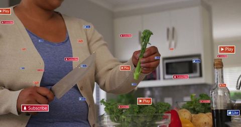 Woman preparing meal in modern kitchen with digital overlay icons