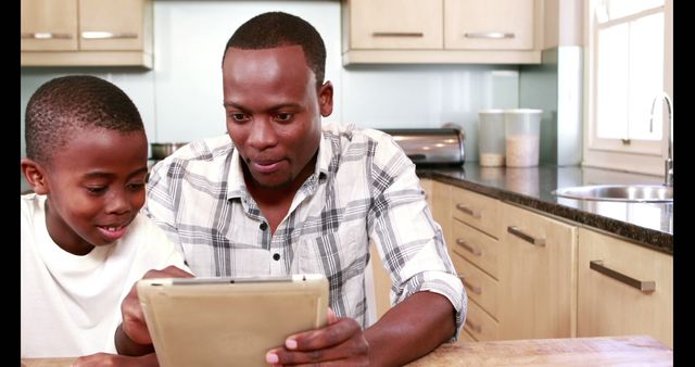 Father And Son Using Digital Tablet In Modern Kitchen - Download Free Stock Images Pikwizard.com