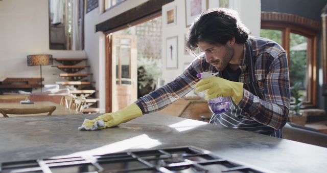 Man Cleaning Kitchen Counter in Modern Home - Download Free Stock Images Pikwizard.com