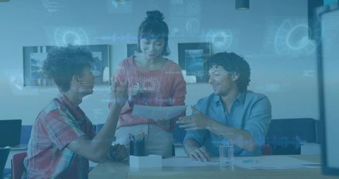 Team collaborating with futuristic HUD overlay at office table, presenting data and insight