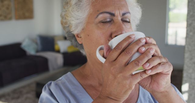 Senior Woman Savoring Hot Drink Indoors - Download Free Stock Images Pikwizard.com