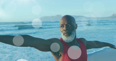 Senior African American Man Practicing Yoga on Beach