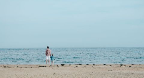 Father and Son Enjoying Serene Beach View
