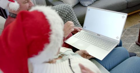 Senior Couple in Christmas Hats with Laptop Celebrating at Home - Download Free Stock Images Pikwizard.com