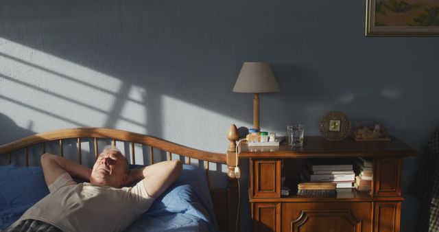 Senior Man Relaxing in Bedroom Morning Light - Download Free Stock Images Pikwizard.com