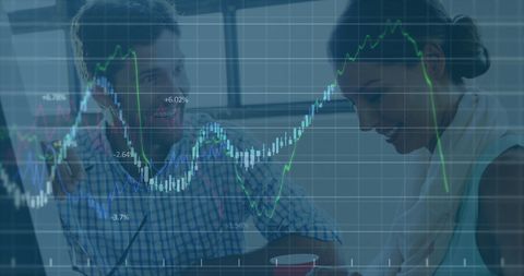 Coworkers Analyzing Financial Growth Data with Overlaid Graphs