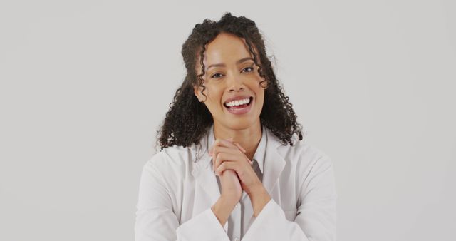 Image of portrait of smiling biracial female doctor holding hands and talking. global medicine and healthcare concept.