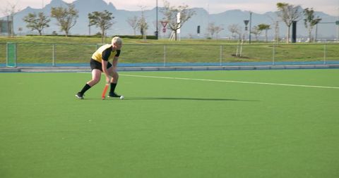 Teenage Athlete Playing Field Hockey on Outdoor Turf