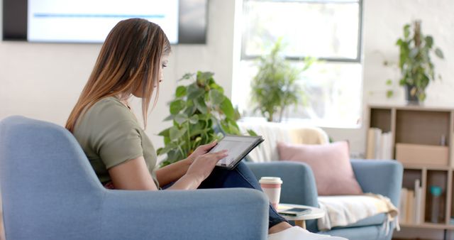 Young Woman Reading Tablet in Cozy Living Room - Download Free Stock Images Pikwizard.com