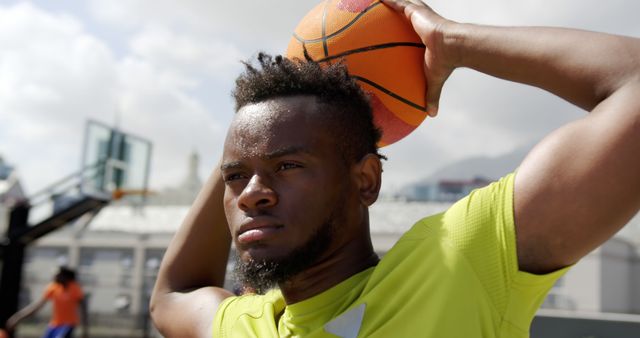 Focused Young Man Preparing to Shoot Basketball Outdoors - Download Free Stock Images Pikwizard.com