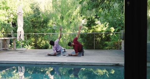 Friends Practicing Outdoor Exercises on Sunny Pool Deck