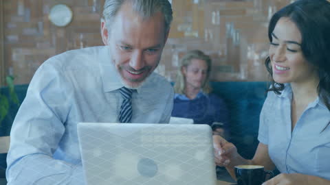 Coworkers Collaborating on Laptop with Scientific Data Overlay