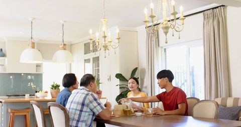 Happy family dining together in bright modern kitchen