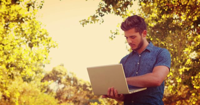 Young Man Using Laptop in Outdoor Park Setting - Download Free Stock Images Pikwizard.com