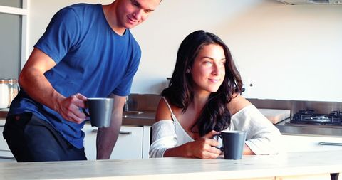 Happy Couple Enjoying Morning Coffee in Bright Kitchen