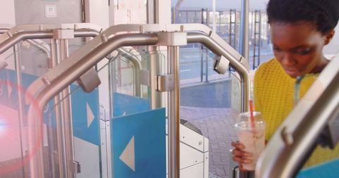 African American Woman Passing Turnstile at Train Station