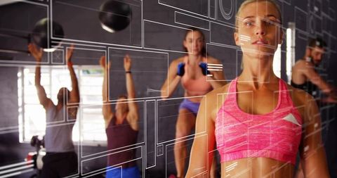 Woman Leading Intense Group Training in Bright Sportswear with Medicine Balls and Dumbbells