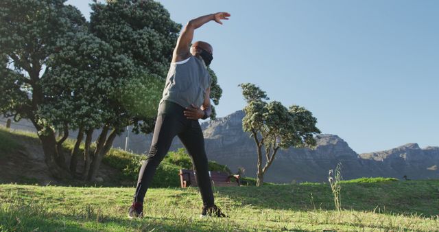 Man Stretching Outdoors in Park - Download Free Stock Images Pikwizard.com