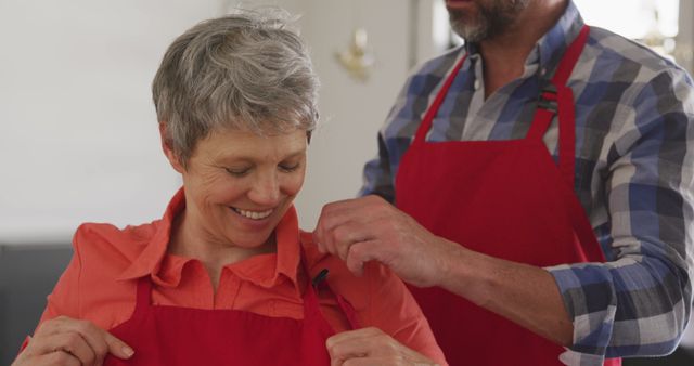 Man and Woman Preparing to Cook with Red Aprons - Download Free Stock Images Pikwizard.com