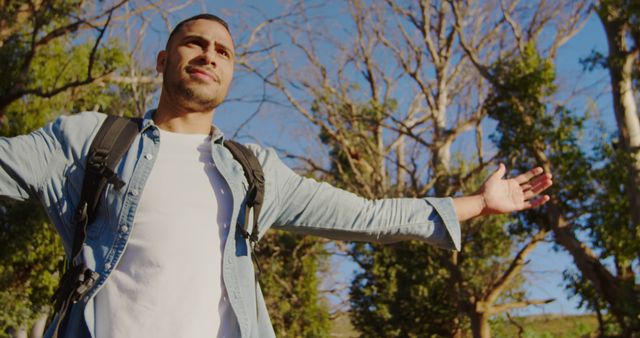 Happy Young Man Enjoying the Outdoors with Arms Outstretched in Nature - Download Free Stock Images Pikwizard.com