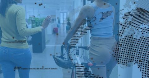 Guiding coworker with commuter bicycle and helmet through modern glass office corridor